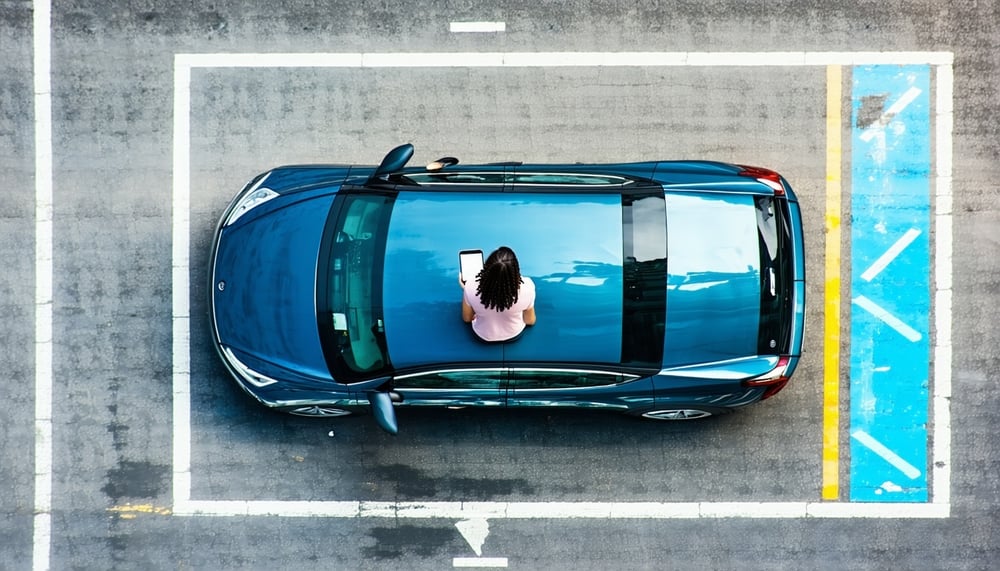 Illustration of a person parking in a reserved spot using a mobile app Illustration of a person parking in a reserved spot using a mobile app